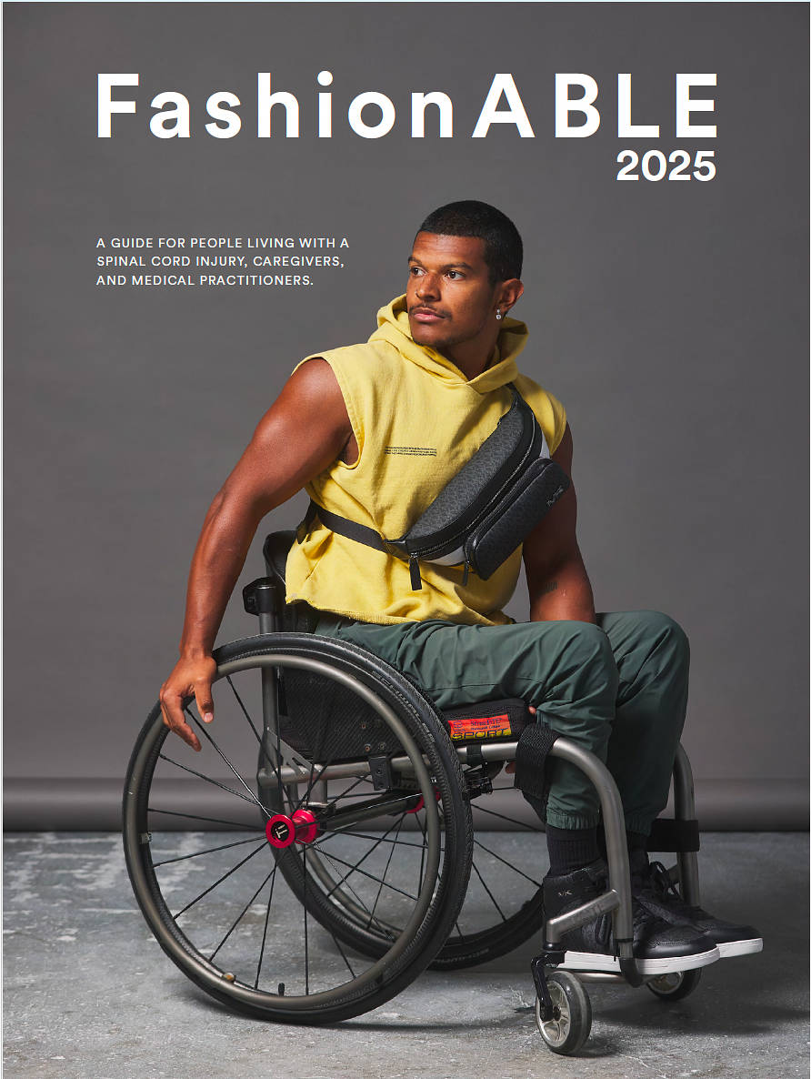 A man seated in a wheelchair wears a sleeveless yellow top and crossbody bag, featured on the cover of “FashionABLE 2025,” a guide for people living with spinal cord injuries, caregivers, and medical practitioners.